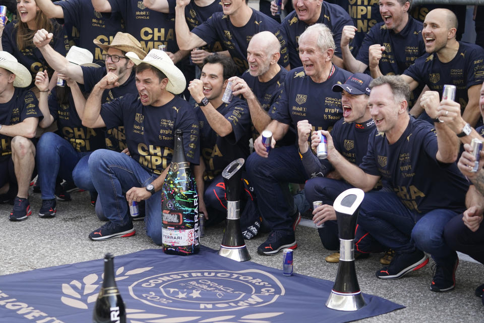 Red Bull driver Sergio Perez, second from left, of Mexico, and Red Bull driver Max Verstappen, second from right, of the Netherlands, celebrate with team members following the F1 U.S. Grand Prix auto race at Circuit of the Americas, Sunday, Oct. 23, 2022, in Austin, Texas. Verstappen won the race and team Red Bull won the constructors' championship. (AP Photo/Darron Cummings)