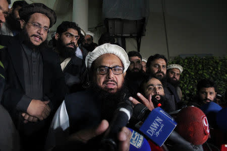 Hafiz Muhammad Saeed, chief of the banned Islamic charity Jamat-ud-Dawa, speaks with media as he is escorted to his home where he will be under house arrest in Lahore, Pakistan January 30, 2017. REUTERS/Stringer
