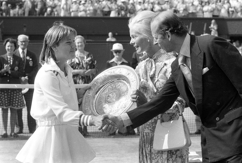 FILE - Chris Evert shakes hands with the Duke of Kent, while the Duchess of Kent presents her with the winner's trophy, after she beat Australia's Evonne Goolagong Cawley in the final of the Women's Singles championship on July 2, 1976. (AP Photo/Bob Dear, File)