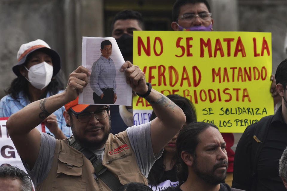 A journalist holds a photo of Luis Enrique Ramirez who was murdered on May 6, during a protest to draw attention to the latest wave of murders of journalists, at the Angel of Independence monument in Mexico City, on Monday, May 9, 2022. Two journalists were shot dead in the state of Veracruz, on the Gulf Coast of Mexico, on Monday, Yessenia Mollinedo Falconi and Sheila Johana García Olivera, director and reporter, respectively, of the online news site El Veraz in Cosoleacaque. (AP Photo/Marco Ugarte)