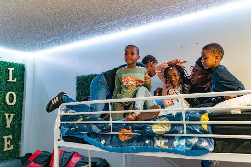 From left, Amerie McKay, 11; Amari Smith, 8; Amor Lucky, 9; Stan McKay; and Amil Pryor, 6, pose for a portrait on the bunk bed in their home.