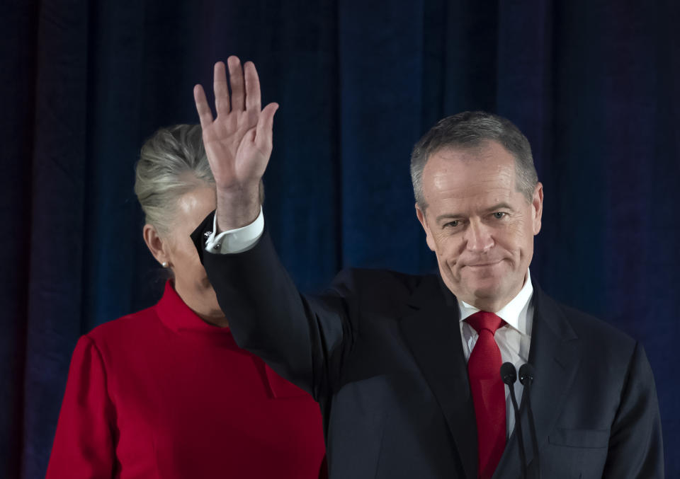 Australian Labor leader Bill Shorten gestures on stage with his wife Chloe, at the Federal Labor Reception in Melbourne, Australia, Saturday, May 18, 2019. Shorten has conceded defeat to Prime Minister Scott Morrison in the country's general election. Shorten made the announcement to supporters of his opposition Labor party late Saturday night in Melbourne. (AP Photo/Andy Brownbill)
