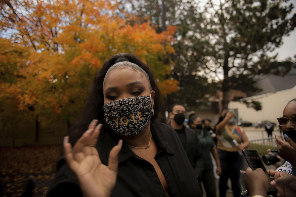 Lizzo reaches for a pen to sign autographs during a campaigns in Detroit for Democratic Presidential Candidate Joe Biden and Kamala Harris on Friday Oct. 23, 2020 in Detroit. (Nicole Hester/Ann Arbor News via AP)