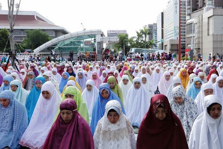 Muslim women attend Eid al-Fitr prayers to mark the end of the holy fasting month of Ramadan in Taipei , Taiwan June 25, 2017. REUTERS/Tyrone Siu