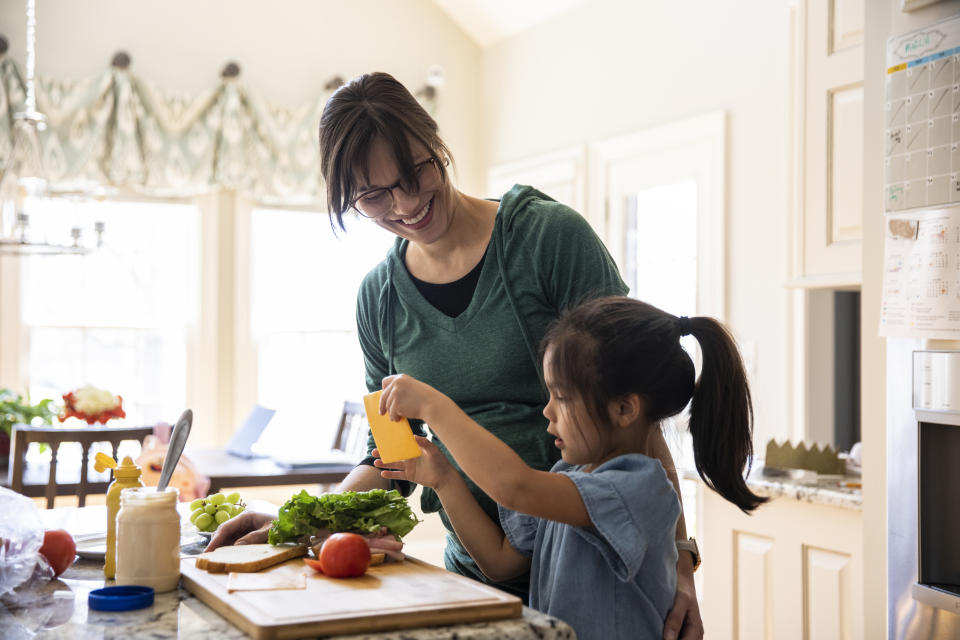 a parent and child cooking together