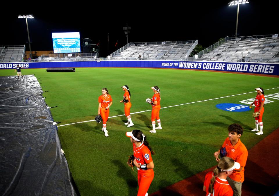 Oklahoma State waits to warm up after a weather delay during a softball game between Oklahoma State Cowgirls and Florida State in the Women's College World Series at USA Softball Hall of Fame Stadium in  in Oklahoma City, Thursday, June, 1, 2023. 