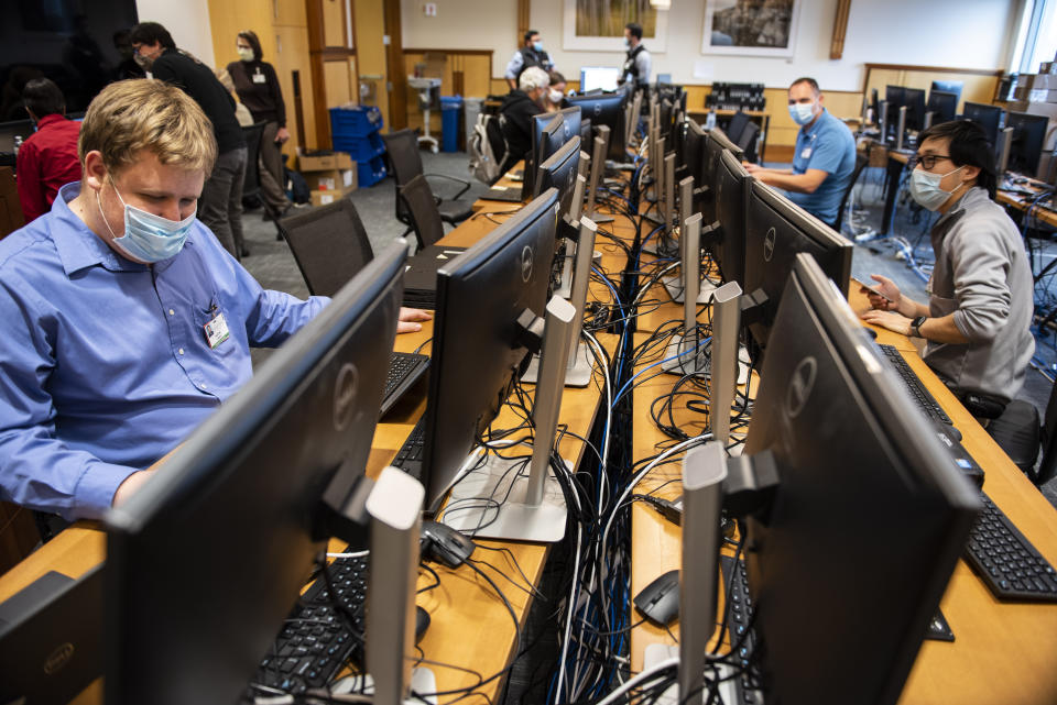 In this photo provided by the University of Vermont Health Network, IT staff at the University of Vermont Medical Center in Burlington, Vt., continue work to scan thousands of the hospital's computer systems for malware on Friday, Nov. 20, 2020, after the Oct. 28 cyberattack forced a shut down of the hospital's electronic medical records system and other key systems. (Ryan Mercer/University of Vermont Health Network via AP)