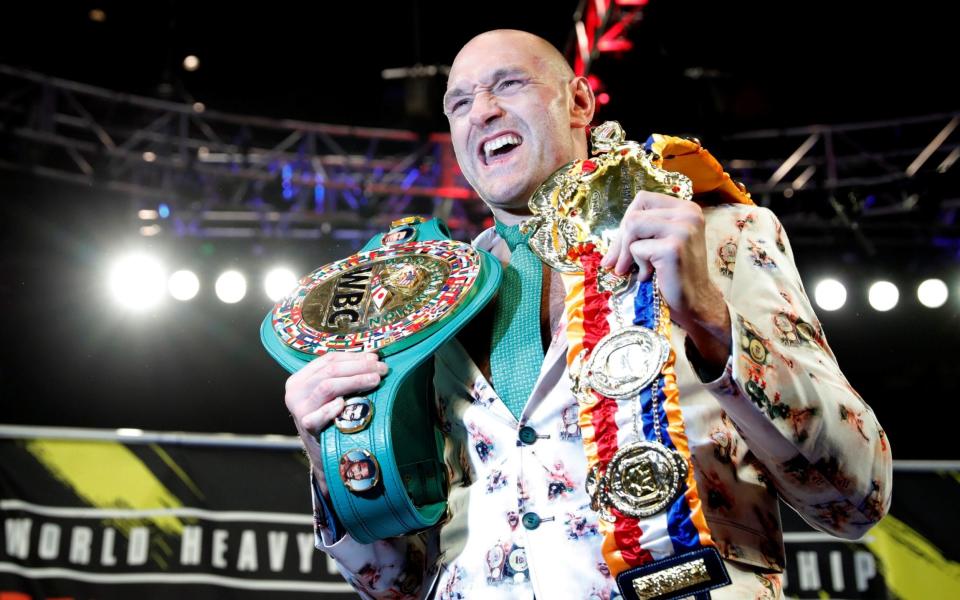 Deontay Wilder v Tyson Fury - WBC Heavyweight Title - The Grand Garden Arena at MGM Grand, Las Vegas, United States - February 22, 2020 Tyson Fury poses with his belts during a press conference after the fight  - REUTERS