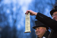 <p>The scroll selected by Punxsutawney Phil that predicts six more weeks of winter is held up for the crowd to see during Groundhog day ceremonies on Feb. 2, 2018 in Punxsutawney, Pa. (Photo: Brett Carlsen/Getty Images) </p>