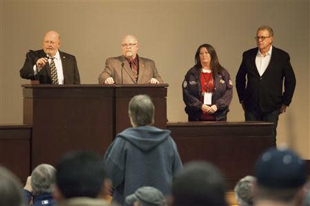 (L-R) Union leaders Mark Johnson, Tom Wroblewski, Susan Palmer and Rich Michalski announce the results of a union vote while speaking at the International Association of Machinists District 751 Headquarters in Seattle, Washington November 13, 2013. Boeing Co machinists soundly rejected an eight-year labour contract extension on Wednesday that would have let them build the company's newest jetliner in Washington, a historic decision that could forever alter the course of Boeing's 97-year presence in the state. International Association of Machinists members voted 67 percent against a deal that would secure an estimated 20 years of work building Boeing's 777X jet, but a deal that would have terminated their pension plan and raised their healthcare costs. REUTERS/David Ryder