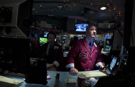 Traders work on the floor of the New York Stock Exchange after the opening bell in New York, December 24, 2013. REUTERS/Carlo Allegri