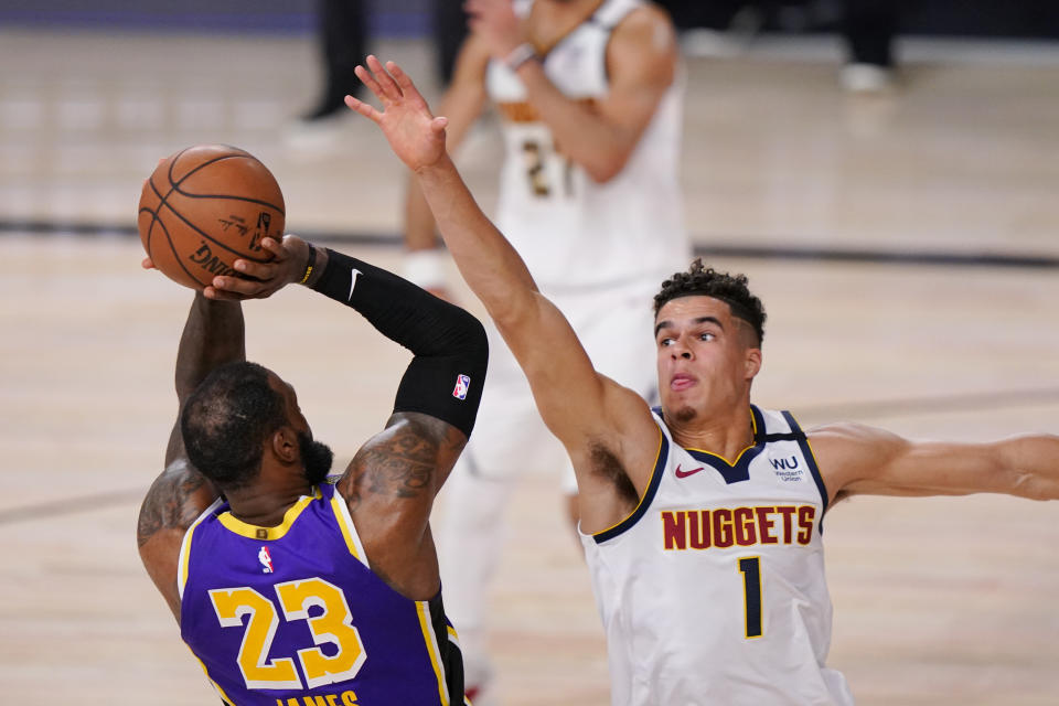 Los Angeles Lakers' LeBron James (23) takes a shot against Denver Nuggets' Michael Porter Jr. (1) during the second half of an NBA conference final playoff basketball game Saturday, Sept. 26, 2020, in Lake Buena Vista, Fla. (AP Photo/Mark J. Terrill)