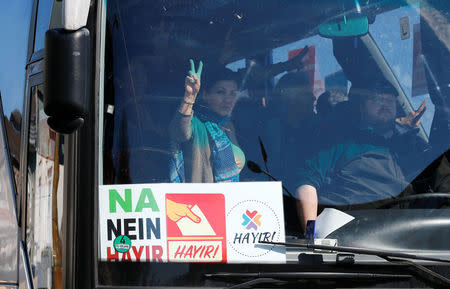 A Kurdish woman flashes a victory sign as she arrives with a group of some 30 Turks of Kurdish descent to vote at the Turkish consulate in Huerth near Cologne, Germany March 27, 2017. REUTERS/Wolfgang Rattay