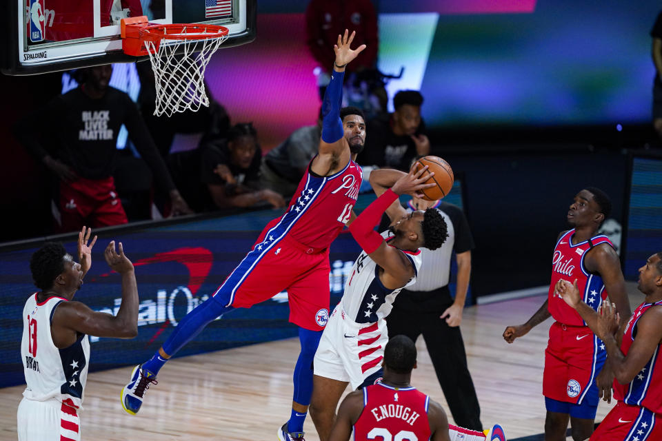 Philadelphia 76ers forward Tobias Harris (12) goes up to block the shot of Washington Wizards forward Troy Brown Jr. (6) during the second half of an NBA basketball game Wednesday, Aug. 5, 2020 in Lake Buena Vista, Fla. (AP Photo/Ashley Landis)