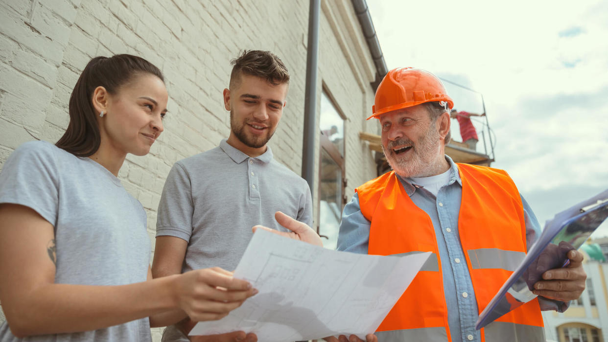 contractor talks with clients of new home