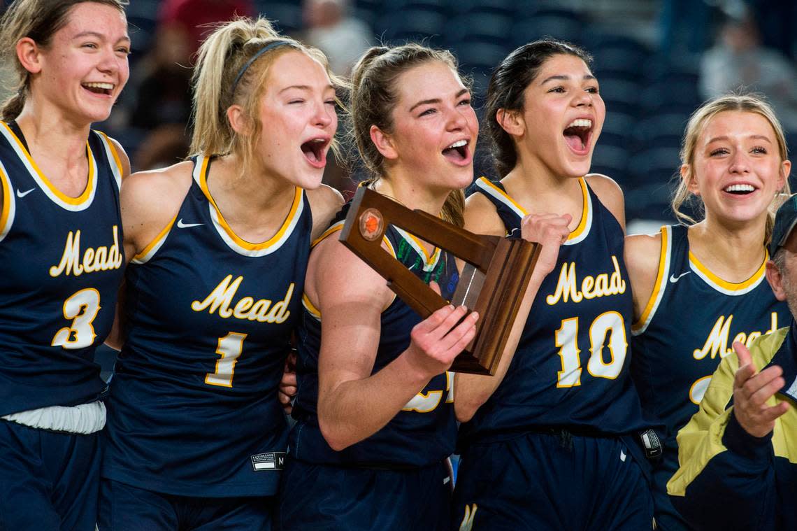 Mead guard Teryn Gardner (24) holds up the trophy following the Panthers’ win over Arlington in the third-fifth place game of the Class 3A girls state basketball tournament on Saturday, March 4, 2023 at the Tacoma Dome in Tacoma, Wash.