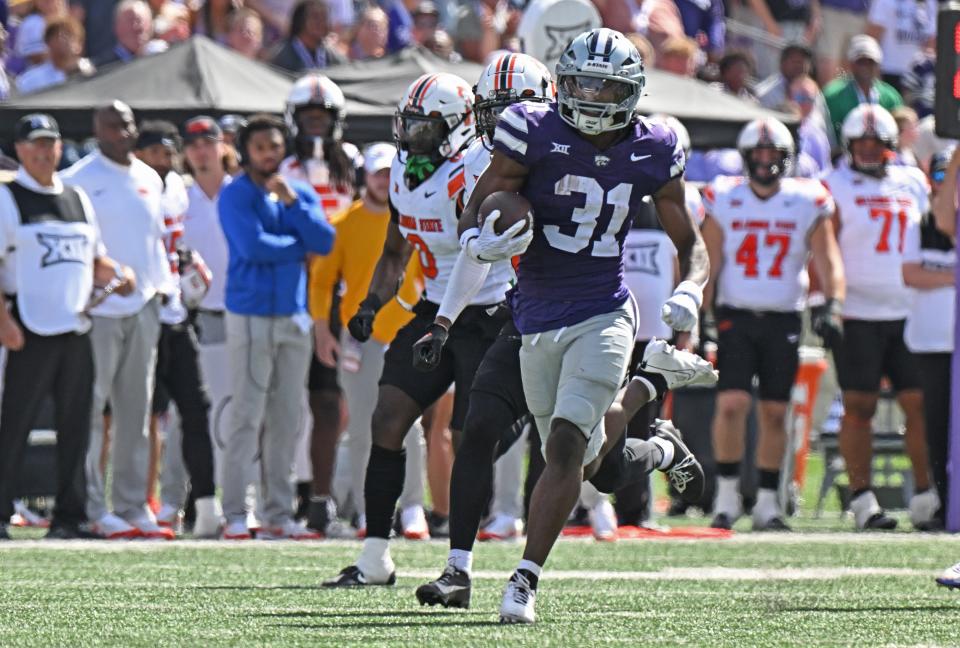 MANHATTAN, KS - SEPTEMBER 28: Running back DJ Giddens #31 of the Kansas State Wildcats rushes for a 66-yard touchdown against the Oklahoma State Cowboys in the second half at Bill Snyder Family Football Stadium on September 28, 2024 in Manhattan, Kansas. (Photo by Peter Aiken/Getty Images)