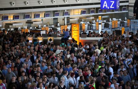People gather at Frankfurt airport terminal after Terminal 1 departure hall was evacuated in Frankfurt, Germany, August 31, 2016. REUTERS/Alex Kraus