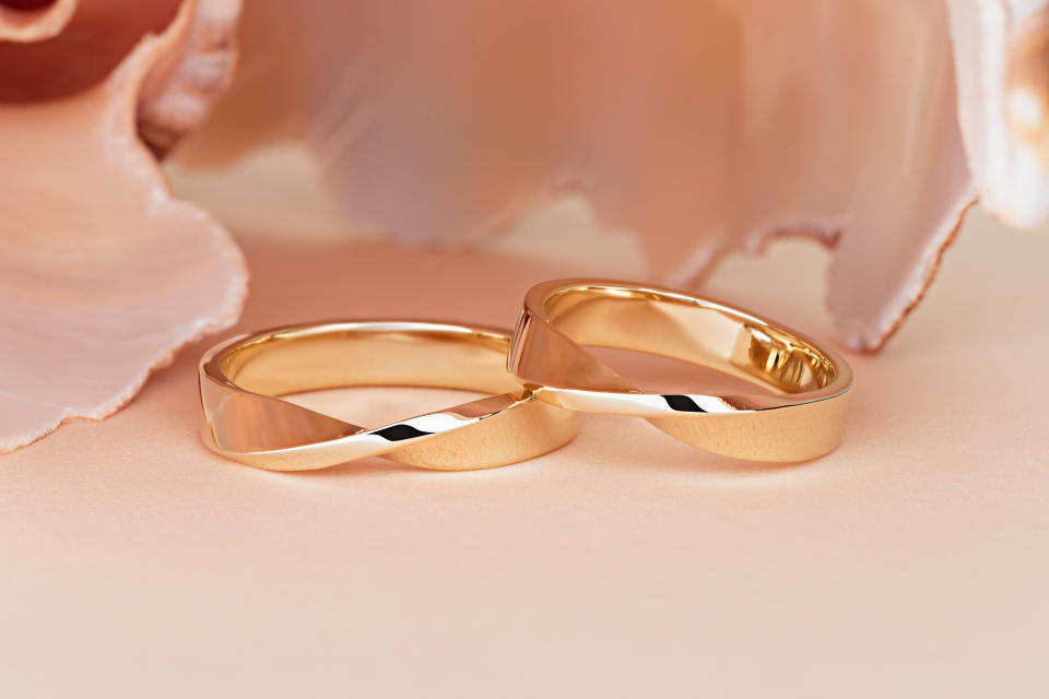 Yellow gold ring bands with Mobius strip shape. Product concept for jeweler. Advertising jewelry still life