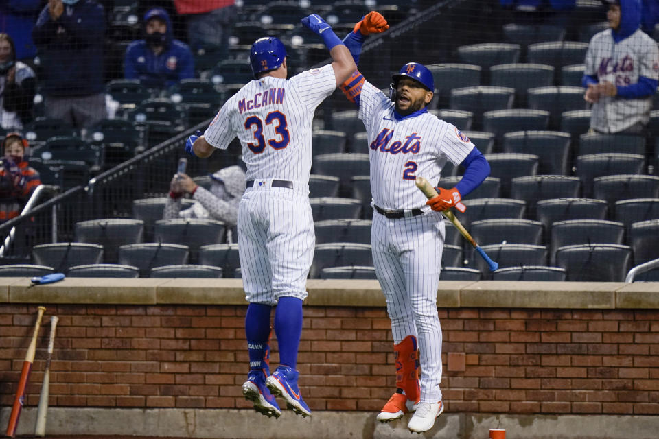 New York Mets' James McCann (33) celebrates with Dominic Smith (2) after hitting a home run during the first inning of the team's baseball game against the Atlanta Braves on Saturday, May 29, 2021, in New York. (AP Photo/Frank Franklin II)