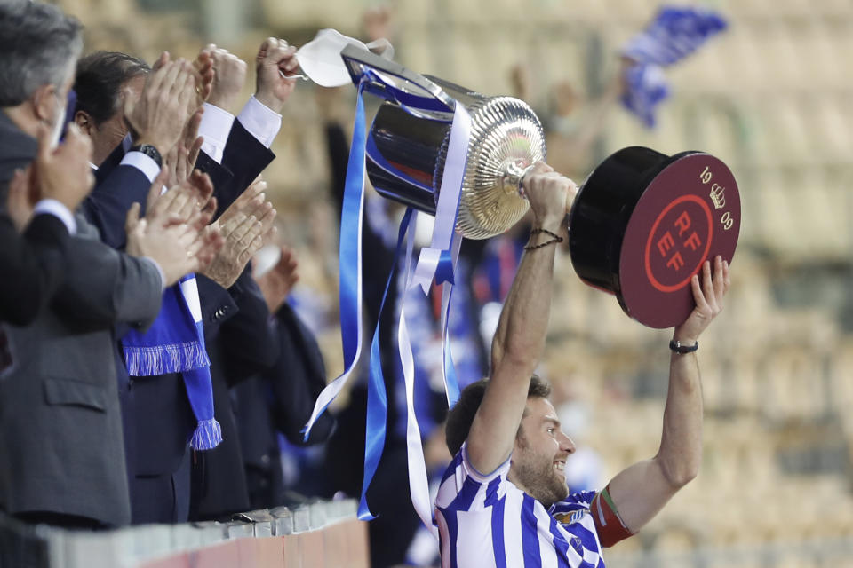 Real Sociedad's Martin Zubimendi celebrates with the trophy after winning the final of the 2020 Copa del Rey, or King's Cup, soccer match between Athletic Bilbao and Real Sociedad at Estadio de La Cartuja in Sevilla, Spain, Saturday April 3, 2021. The game is the rescheduled final of the 2019-2020 competition which was originally postponed due to the coronavirus pandemic. (AP Photo/Angel Fernandez)