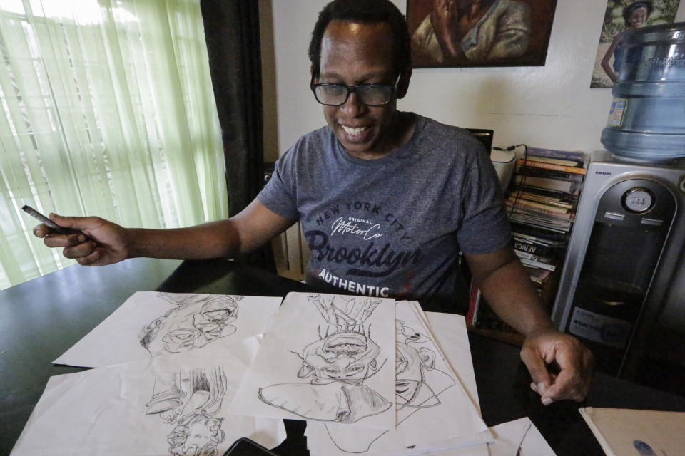 Kenyan cartoonist and commentator Patrick Gathara works on drawing cartoons at his house in Nairobi, Kenya, Thursday, Nov. 5, 2020. As the United States twists itself into knots over its most contentious vote in decades, Gathara has spun out a widely read alternate commentary on Twitter, drawing freely from cliches that long have been aimed at elections in Africa. (AP Photo/Khalil Senosi)