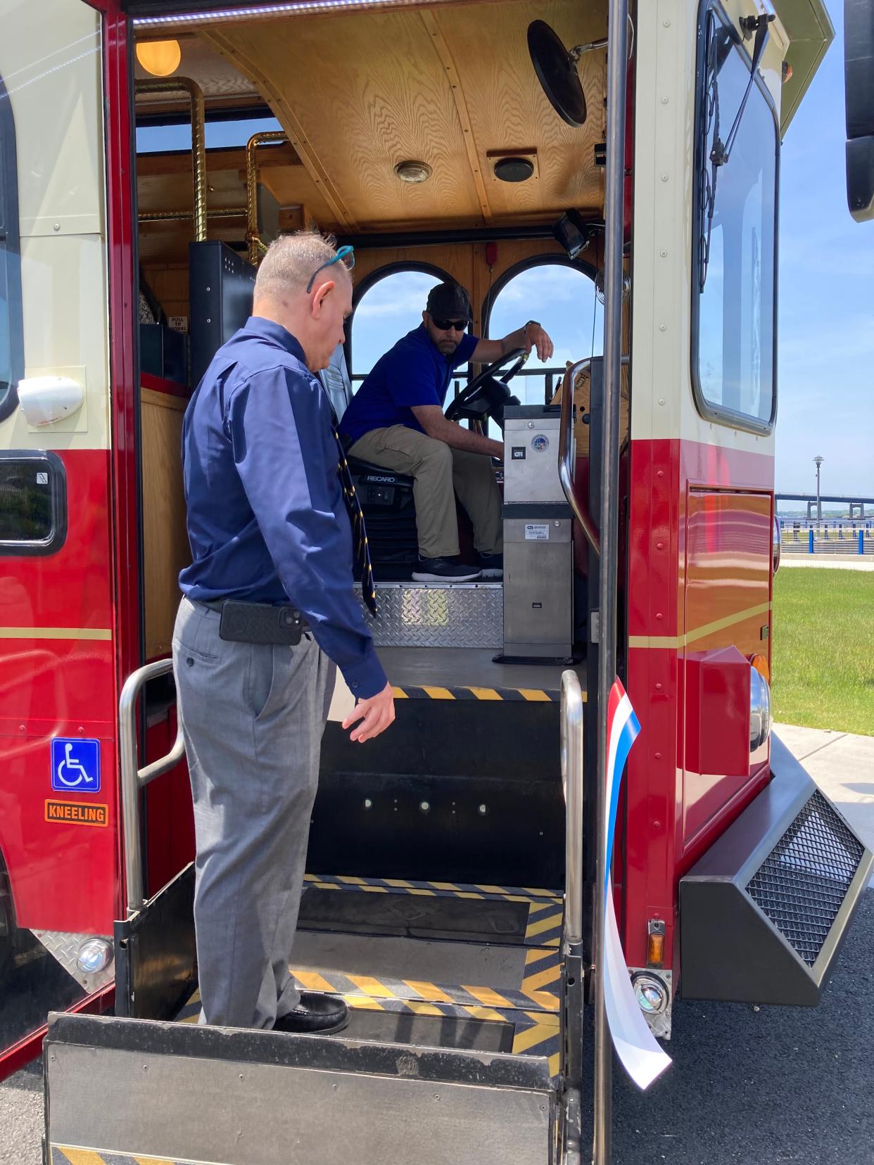 Al Oliveira, director of city operations, demonstrates the trolley's new handicap accessible lift.