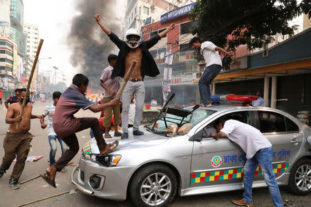 Bangladesh Nationalist Party activists vandalize a police vehicle during clashes in Dhaka, Bangladesh, Novemver 14, 2018. REUTERS/Stringer