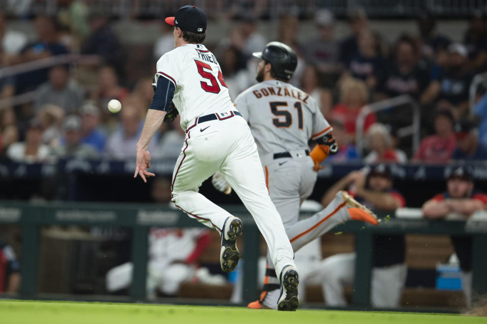 San Francisco fielder Luis Gonzalez (51) beats the throw to first base by Atlanta Braves starting pitcher Max Fried (54) during the eighth inning of a baseball game, Monday, June 20, 2022, in Atlanta. (AP Photo/Hakim Wright Sr.)