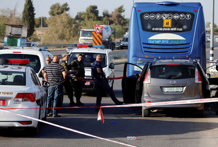 An Israeli policeman inspects the scene of a Palestinian car ramming attack at the Gush Etzion Junction, south of the West Bank city of Bethlehem April 19, 2017. REUTERS/Mussa Qawasma