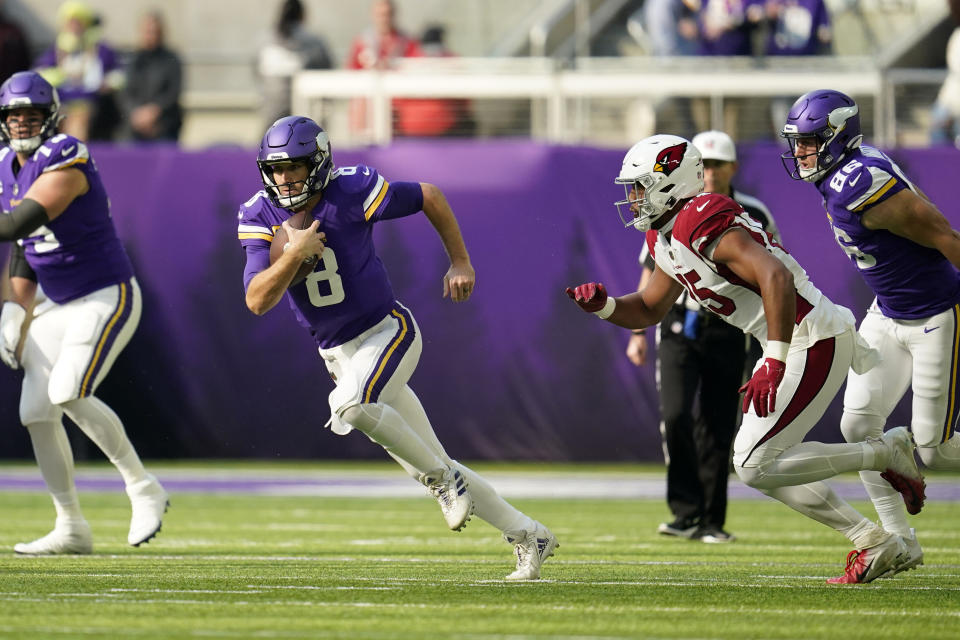Minnesota Vikings quarterback Kirk Cousins (8) scrambles up field during the first half of an NFL football game against the Arizona Cardinals, Sunday, Oct. 30, 2022, in Minneapolis. (AP Photo/Abbie Parr)
