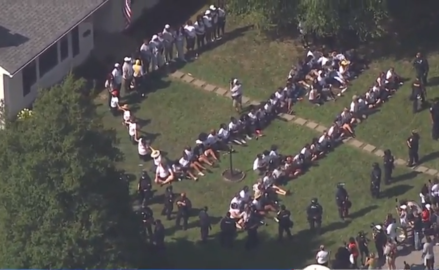 Protesters sit on the lawn of Kentucky Attorney General Daniel Cameron demanding justice for Breonna Taylor on Tuesday, July 14, 2020. / Credit: WLKY-TV