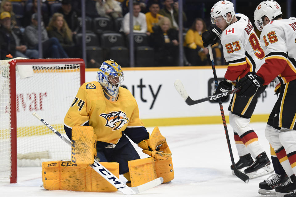 Nashville Predators goaltender Juuse Saros (74), of Finland, gloves a shot during the first period of an NHL hockey game against the Calgary Flames, Thursday, Feb. 27, 2020, in Nashville, Tenn. (AP Photo/Mark Zaleski)