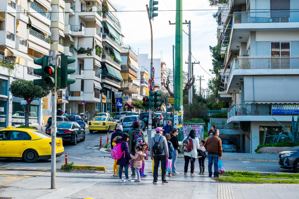 family crossing busy street