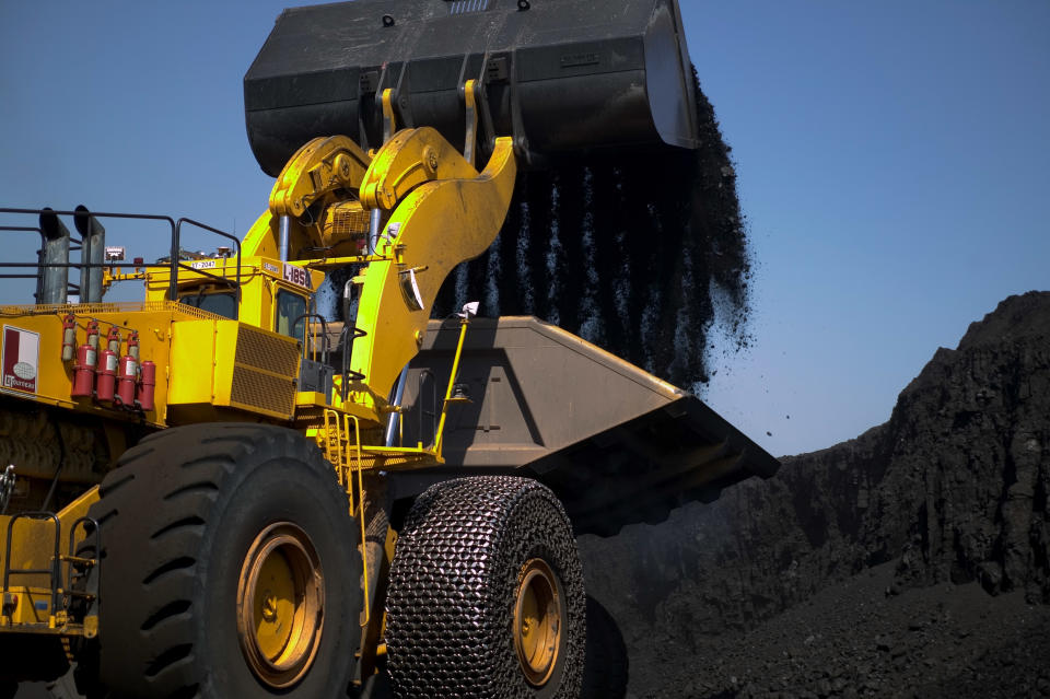 GILLETTE, WY -  JUNE 13:  (US NEWS AND WORLD REPORT AND NEWSWEEK OUT)  A Letourneau front-end bucket loader capable of moving 47 tons with one pass loads a truck carrying 200 tons of coal at the Buckskin Mine,  on June 13, 2006 in Gillette, Wyoming. The Letourneau loader rides on 12 foot diameter tires. Due to a global tire shortage for heavy vehicles, tires can cost anywhere from $21,000 (allocated from tire companies) to over $70,000 on the spot market. The open pit Buckskin Mine is a medium size operation owned and operated by Kiewit Mining Group. The Buckskin Mine produces 20 million tons of low sulfur and low BTU coal per year. Wyoming coal sells for $6.50 per ton (average) compared with high sulfur, high BTU Appalachian coal, now at over $60 per ton. Wyoming coal is transported by rail east to St. Louis, Detroit, Chicago and eventually the eastern U.S. for power generation. (Photo by Robert Nickelsberg/Getty Images)