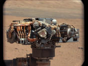 This image shows the Mars Hand Lens Imager (MAHLI) on NASA's Curiosity rover, with the Martian landscape in the background. The image was taken by Curiosity's Mast Camera on the 32nd Martian day, or sol, of operations on the surface (Sept. 7, 2