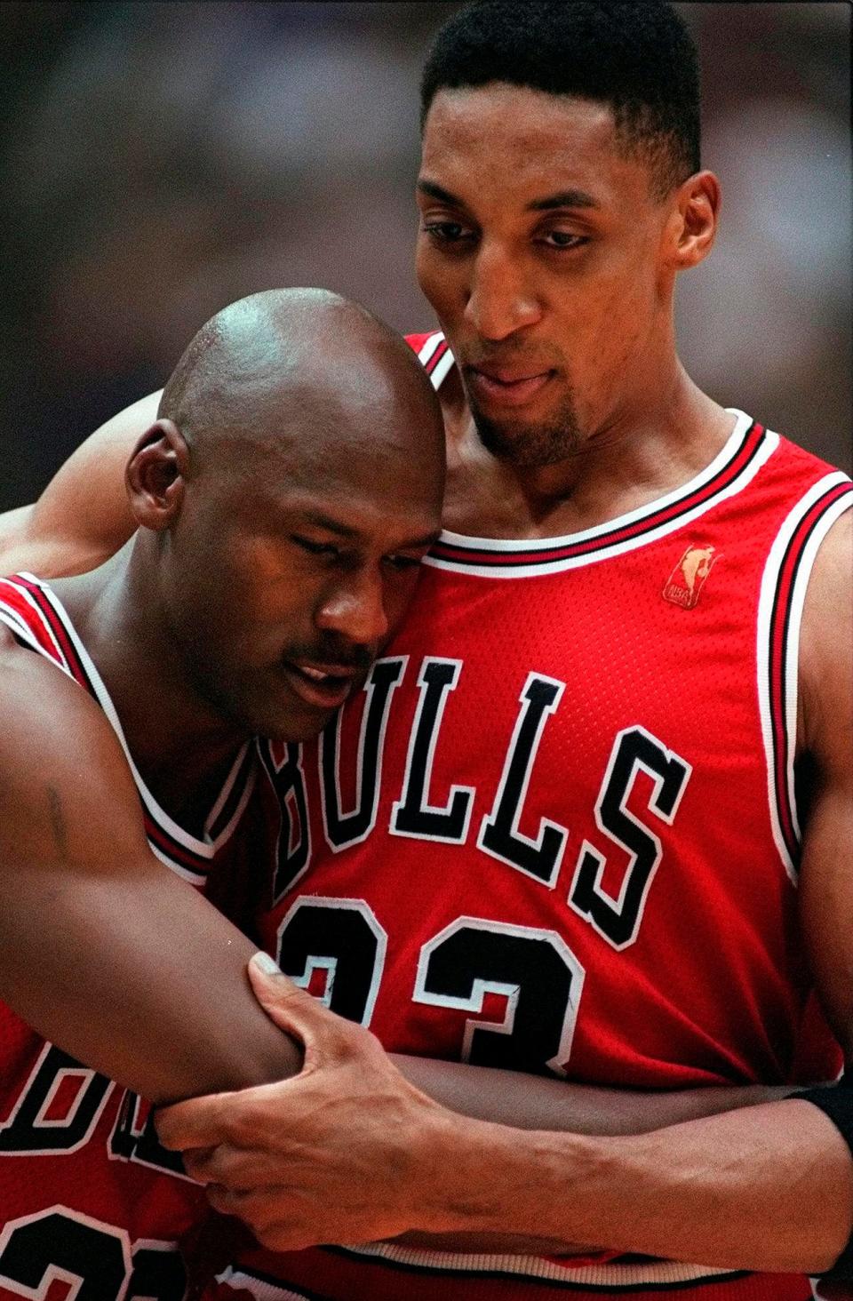 Scottie Pippen, right, embraces an exhausted Michael Jordan following the Chicago Bulls' win in the "Flu Game" -- Game 5 of the 1997 NBA Finals against the Utah Jazz.