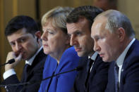 Ukraine's President Volodymyr Zelenskiy, left, German Chancellor Angela Merkel, French President Emmanuel Macron, third left and Russian President Vladimir Putin, right, attend a joint news conference at the Elysee Palace in Paris, Monday Dec. 9, 2019. Russian President Vladimir Putin and Ukrainian President Volodymyr Zelenskiy met for the first time Monday at a summit in Paris to try to end five years of war between Ukrainian troops and Russian-backed separatists. (Charles Platiau/Pool via AP)
