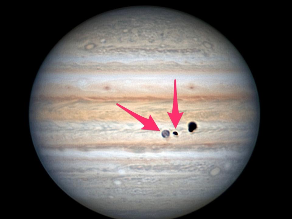 jupiter moons transiting with pink arrow pointing to europa with ganymede's shadow