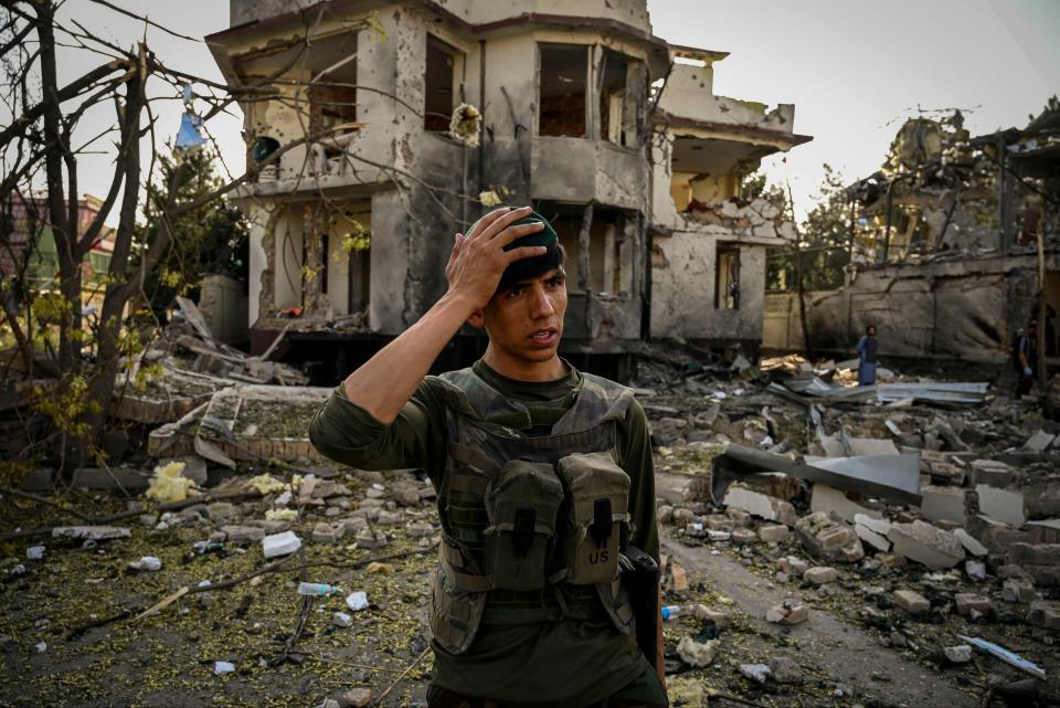 Car bomb blast:  an Afghan soldier at the scene of the explosion in Kabul. At least eight people died and 20 injured near the minister’s villa (AFP via Getty Images)