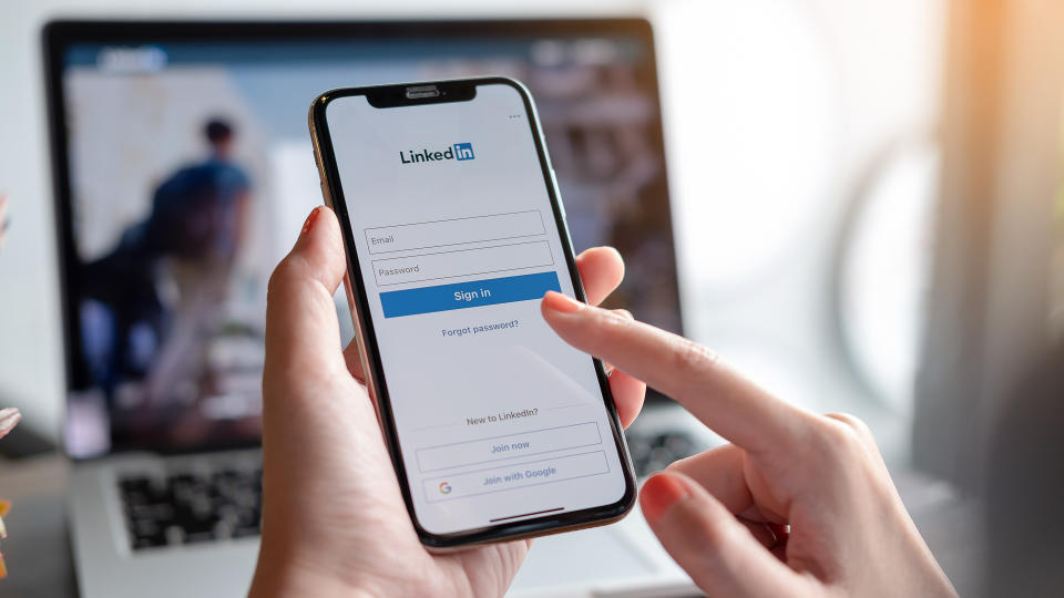 woman using LinkedIn on smartphone