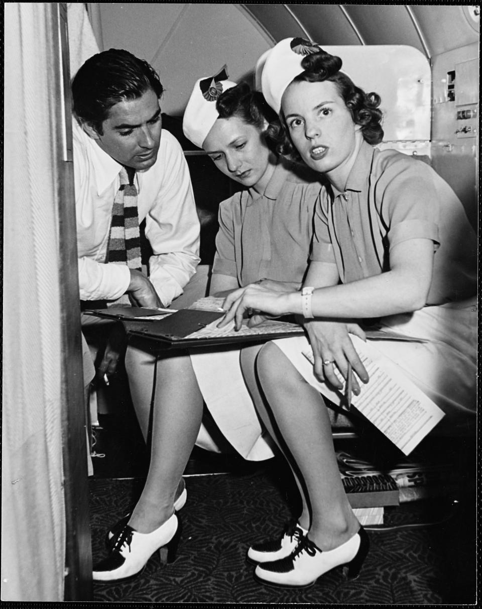 Two&nbsp;flight attendants with actor Tyrone Power on TWA&rsquo;s Stratoliner&nbsp;in 1940.