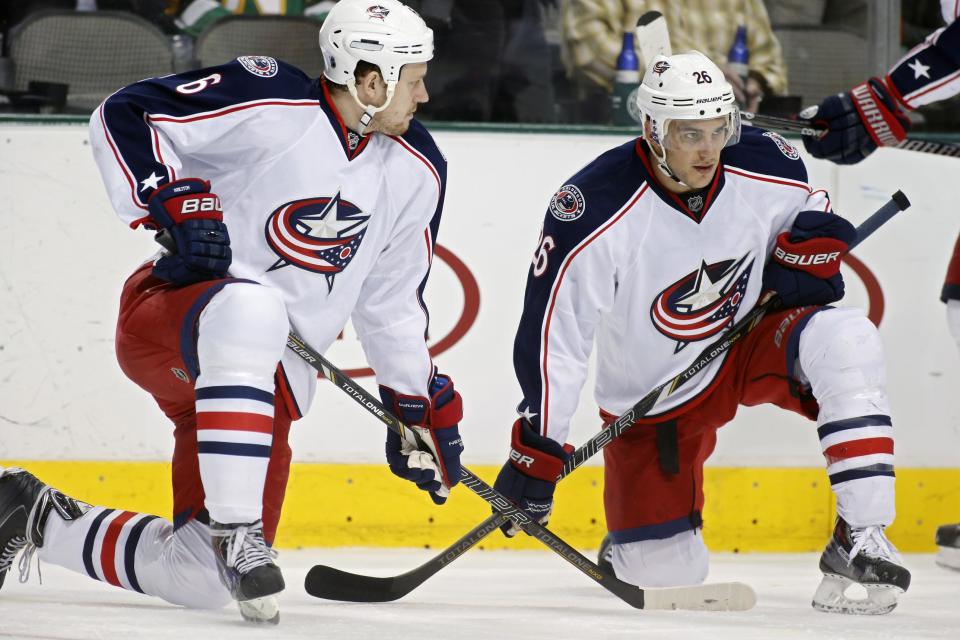 Columbes Blue Jackets defenseman Nikita Nikitin (6), of Russia, and right wing Corey Tropp (26) take a knee on the ics after play was stopped for a medical emergency in the first period of an NHL Hockey game against the Dallas Stars Monday, March 10, 2014, in Dallas. (AP Photo/Sharon Ellman)