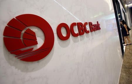 A woman walks into an Oversea-Chinese Banking Corp (OCBC) Premier Banking branch in Singapore February 11, 2015. REUTERS/Edgar Su/Files