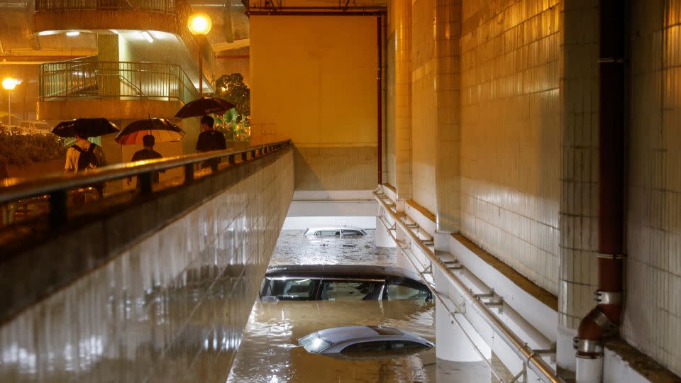 Vehicles submerged in a flooded parking lot in Hong Kong on September 8, 2023. - Tyrone Siu/Reuters