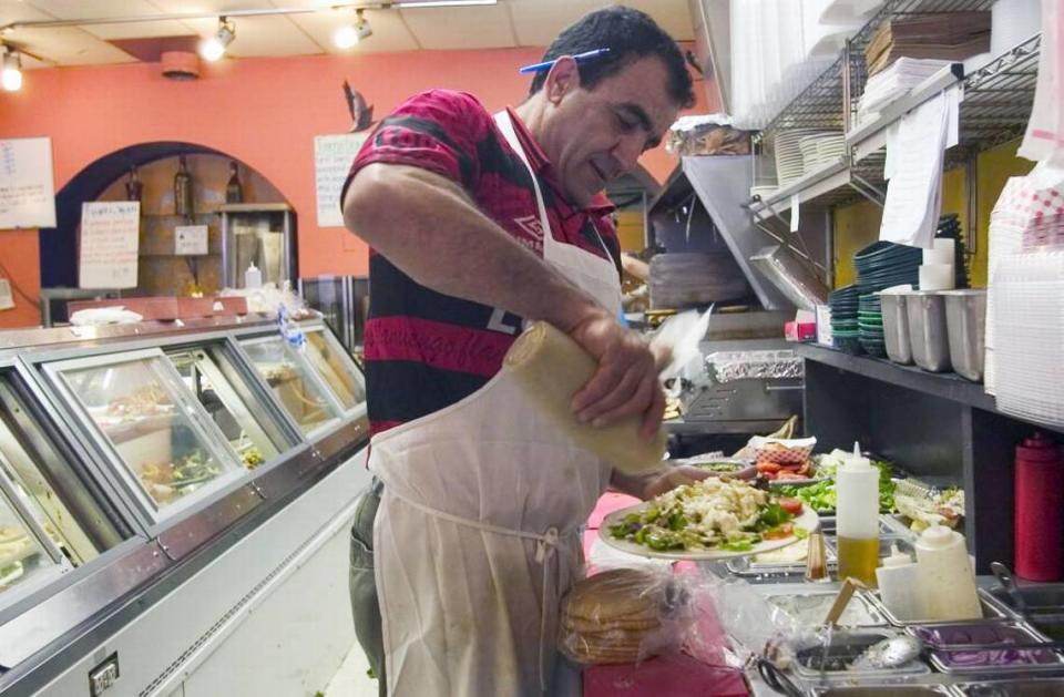 Jamil Kadoura, owner of Mediterranean Deli located on West Franklin Street, at work in his restaurant in 2017.