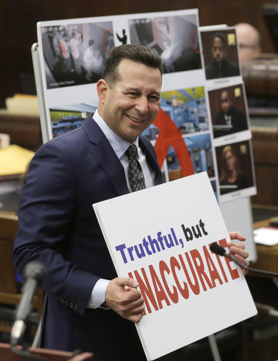 Defense attorney Jose Baez holds a placard while presenting closing arguments in the trial of former New England Patriots tight end Aaron Hernandez, at Suffolk Superior Court, Thursday, April 6, 2017, in Boston. Hernandez is on trial for the July 2012 killings of Daniel de Abreu and Safiro Furtado who he encountered in a Boston nightclub. The former NFL player is already serving a life sentence in the 2013 killing of semi-professional football player Odin Lloyd. (AP Photo/Steven Senne, Pool)