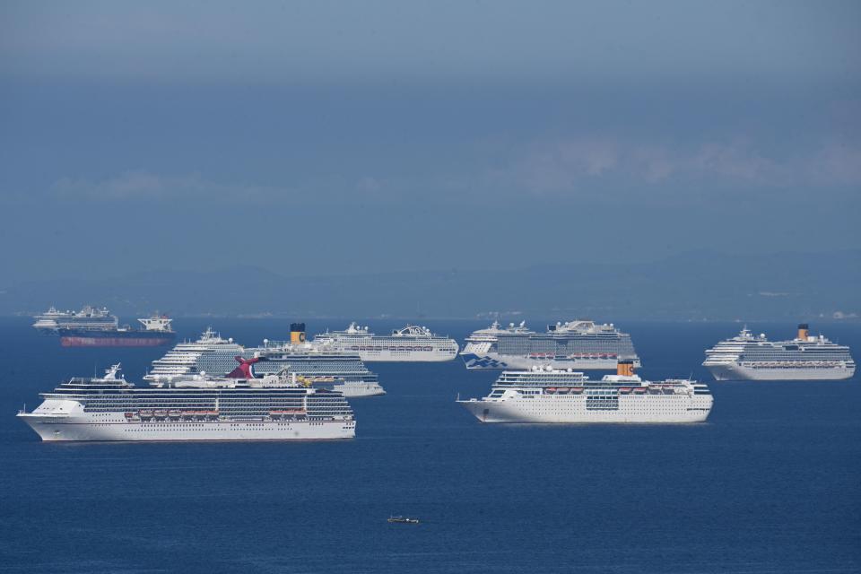 A general view shows cruise ships anchored at Manila Bay on May 31, 2020. - More than 20 cruise ships are anchored at Manila Bay waiting for disembarkation clearance from authorities for their Filipino crews who have undergone swab tests for the COVID-19 coronavirus, according to the Philippine coast guard. Seafarers and other migrant workers are required to undergo a two-week quarantine and coronavirus testing before they are allowed to return home. (Photo by Ted ALJIBE / AFP) (Photo by TED ALJIBE/AFP via Getty Images)