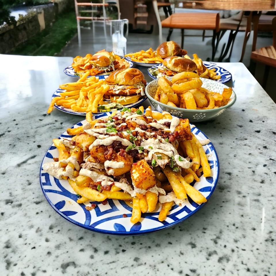 Poutine, front center, is one of the new appetizers customers will find at Dac's Smokehouse. The dish includes meat, fries, gravy, garlic white cheddar cheese curds and more.