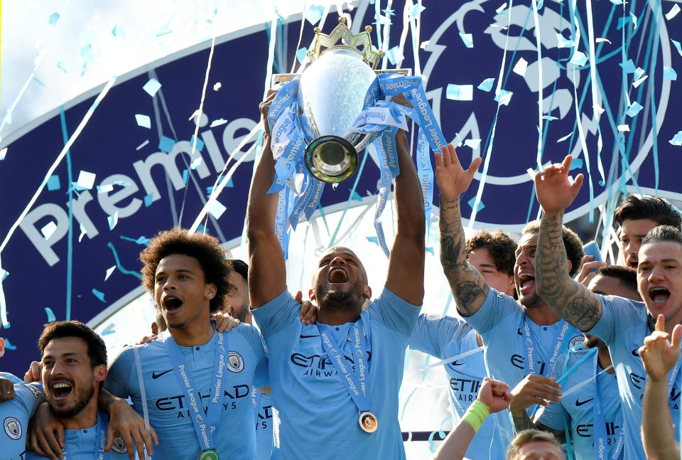 Soccer Football - Premier League - Brighton & Hove Albion v Manchester City - The American Express Community Stadium, Brighton, Britain - May 12, 2019  Manchester City's Vincent Kompany lifts the trophy as they celebrate winning the Premier League               REUTERS/Toby Melville  EDITORIAL USE ONLY. No use with unauthorized audio, video, data, fixture lists, club/league logos or "live" services. Online in-match use limited to 75 images, no video emulation. No use in betting, games or single club/league/player publications.  Please contact your account representative for further details.